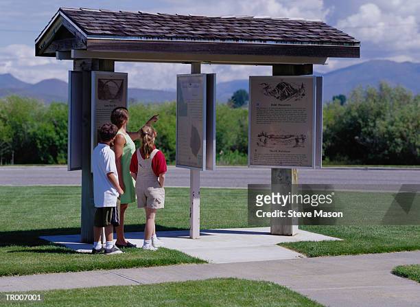 mother and children reading tourist information - steve stock pictures, royalty-free photos & images