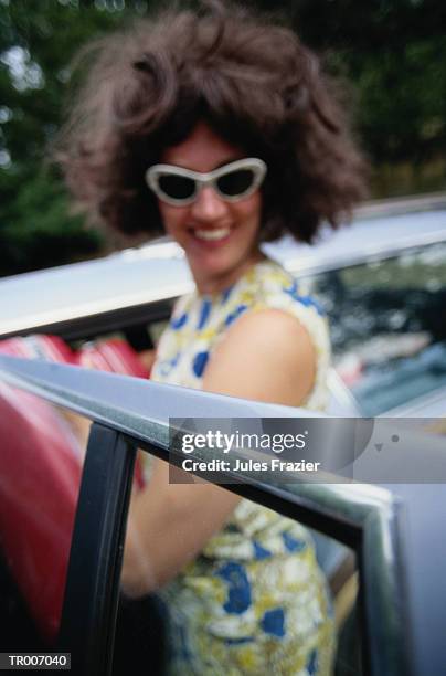 woman putting luggage in the car - only mid adult women stock pictures, royalty-free photos & images