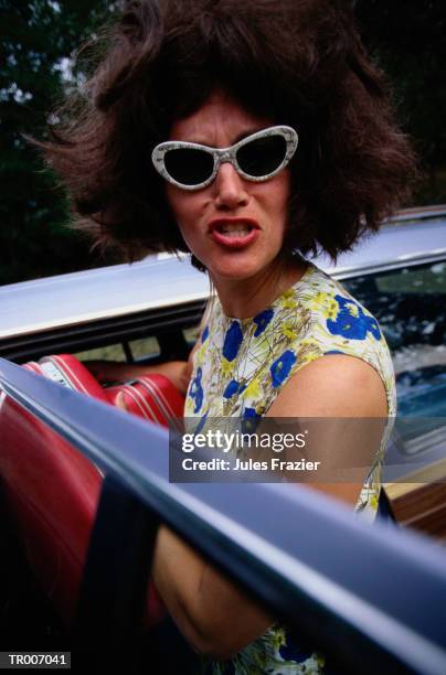 woman putting luggage in the car - only mid adult women stock pictures, royalty-free photos & images