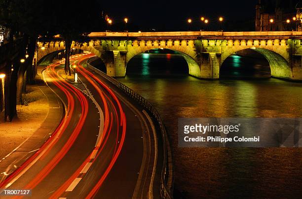 night traffic along the seine river - vehicle light stockfoto's en -beelden