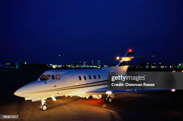 airplane on a runway at dusk - reese stockfoto's en -beelden