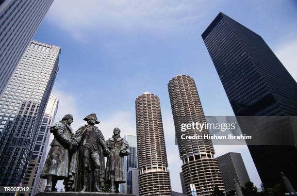 skyscrapers and statue in chicago - revolution monument stock pictures, royalty-free photos & images