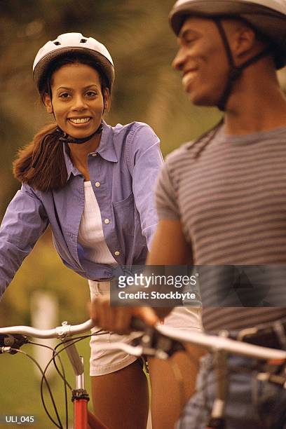 woman and man riding bicycles - human powered vehicle stock pictures, royalty-free photos & images