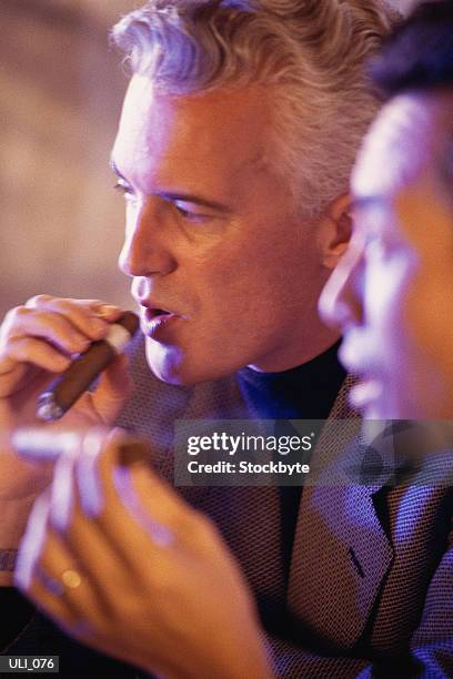 two men smoking cigars - 2nd annual leaders of spanish language television awards after party red stockfoto's en -beelden