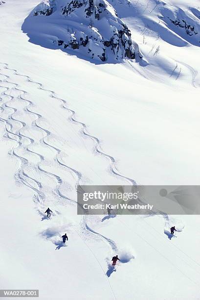 heli-skiing, five people descending slope, aerial view - heli skiing stock pictures, royalty-free photos & images