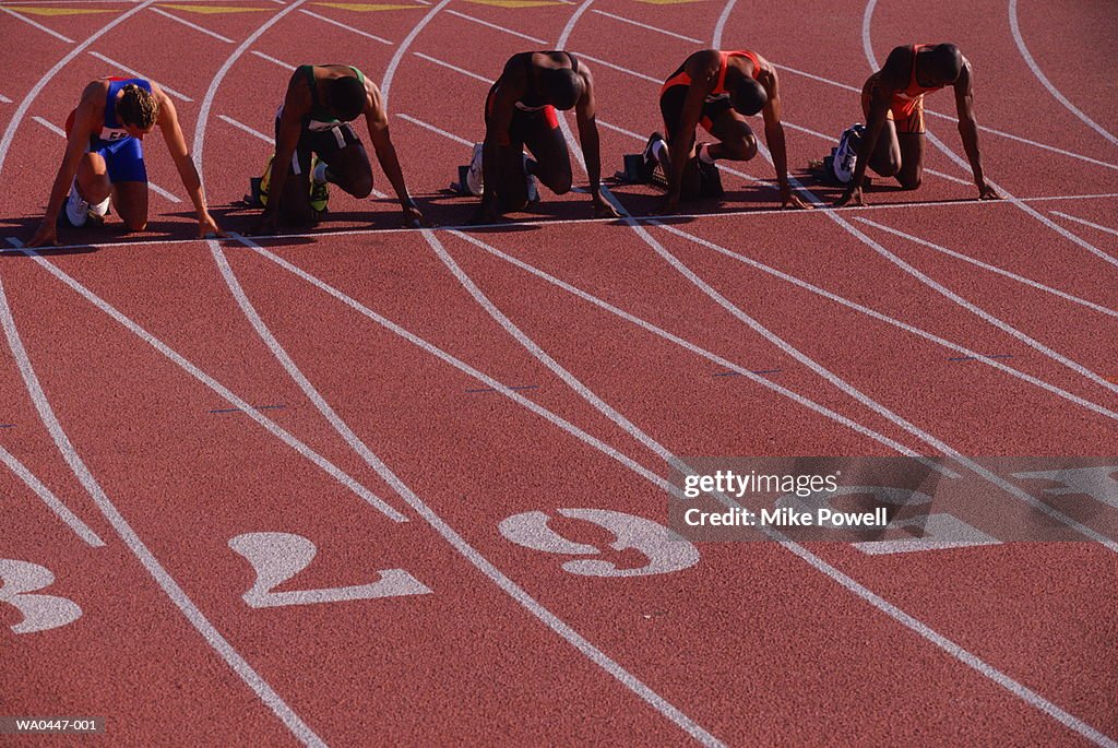 Athletics, sprinters waiting in starting blocks