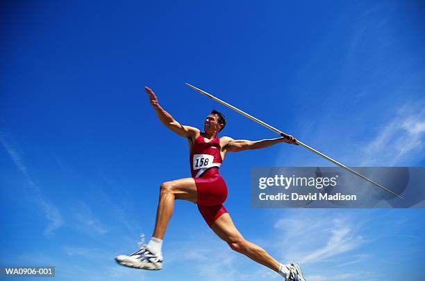 athletics, javelin competitor in action, low angle view - dardo prova de campo - fotografias e filmes do acervo