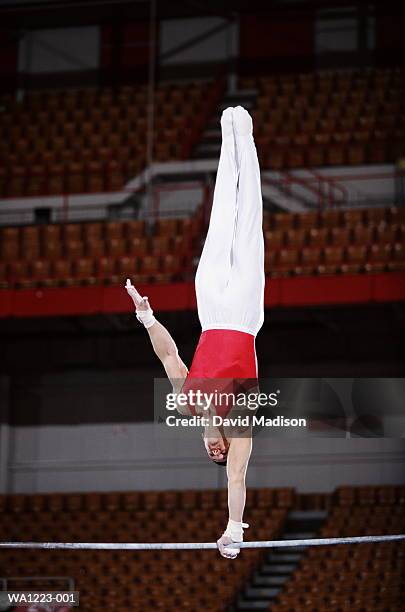high bar gymnast - gymnastics horizontal bar stock pictures, royalty-free photos & images