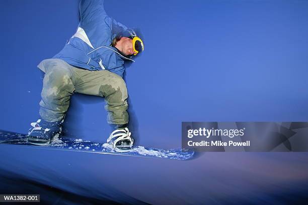 snowboarder in mid-air - snowboard jump close up stock pictures, royalty-free photos & images