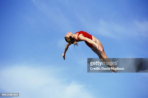 female diver in mid-air - dive stock pictures, royalty-free photos & images