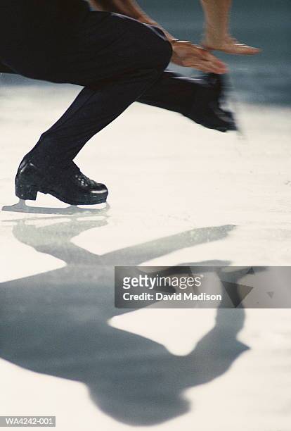 male figure skater's shadow on ice - patinaje artístico fotografías e imágenes de stock
