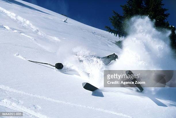 skier falling on snow - wipeout sportunfall stock-fotos und bilder