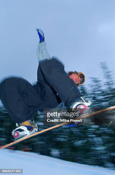 snowboarder in mid-air jump, leaning back - snowboard jump close up stock pictures, royalty-free photos & images