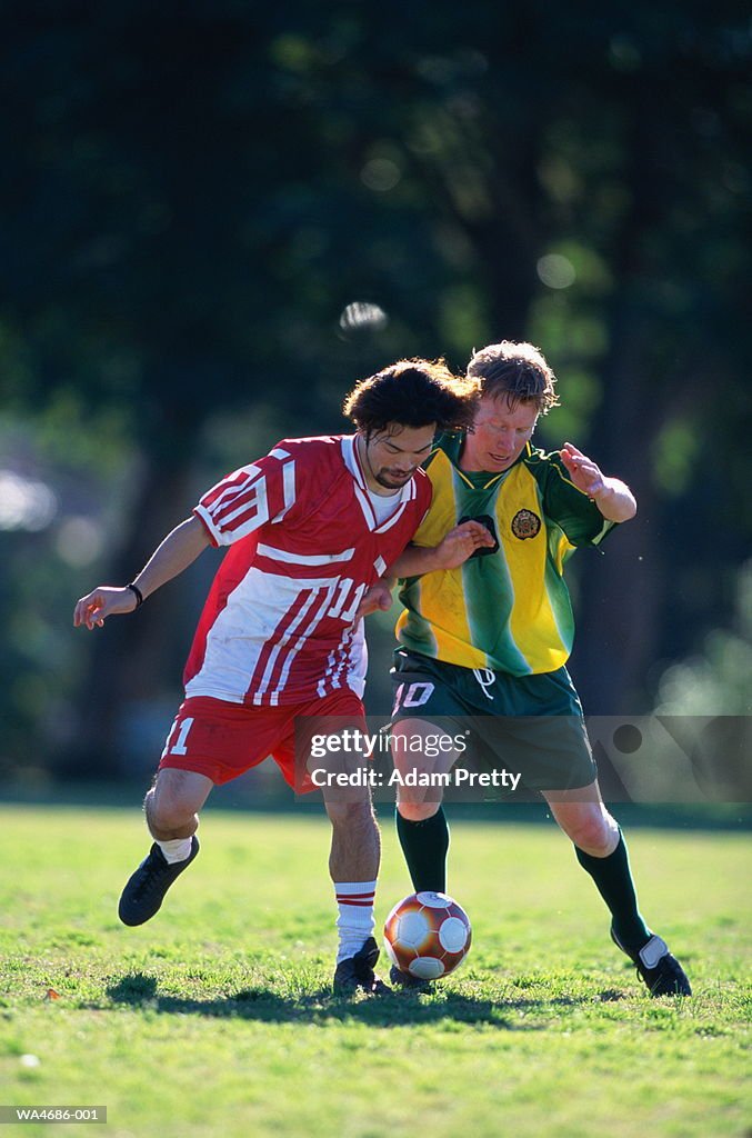 Two soccer players competing for ball