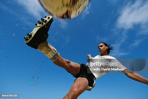 soccer player kicking ball, low angle view, close-up - jugador futbol fotografías e imágenes de stock