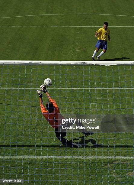 soccer goalie reaching for ball - diving to the ground stock pictures, royalty-free photos & images