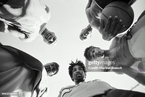 group of street basketball players in a circle, low angle view (b&w) - view from below fotografías e imágenes de stock