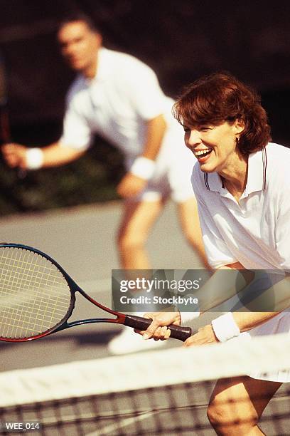 woman and man playing mixed doubles tennis - sports competition format stock pictures, royalty-free photos & images