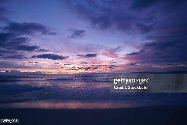cloudy sky and sea at sunset - altostratus stock-fotos und bilder