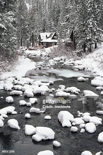 winter view of mountain stream with cabin in distance - pinaceae imagens e fotografias de stock