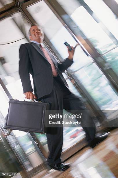 businessman in revolving door - door stockfoto's en -beelden