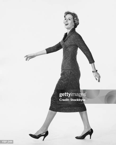 woman walking and smiling - striding stock pictures, royalty-free photos & images