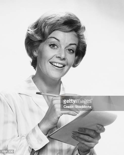 woman holding pencil and paper - only mid adult women stock pictures, royalty-free photos & images