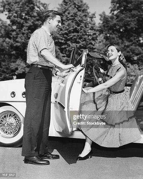 man holding car door open for woman - personal land vehicle stock pictures, royalty-free photos & images