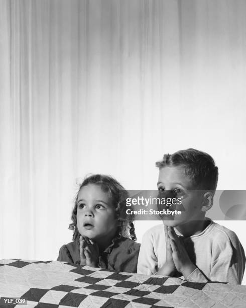 girl and boy saying bedtime prayers - 1950s bedroom stock pictures, royalty-free photos & images