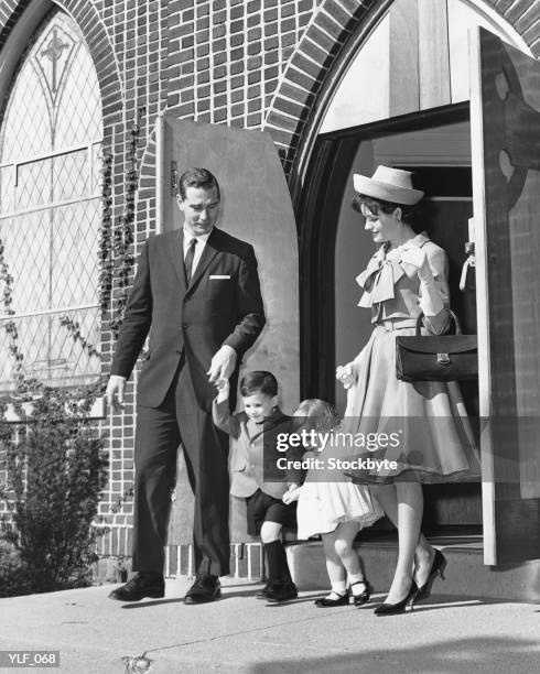 family leaving church - zondagse kleren stockfoto's en -beelden