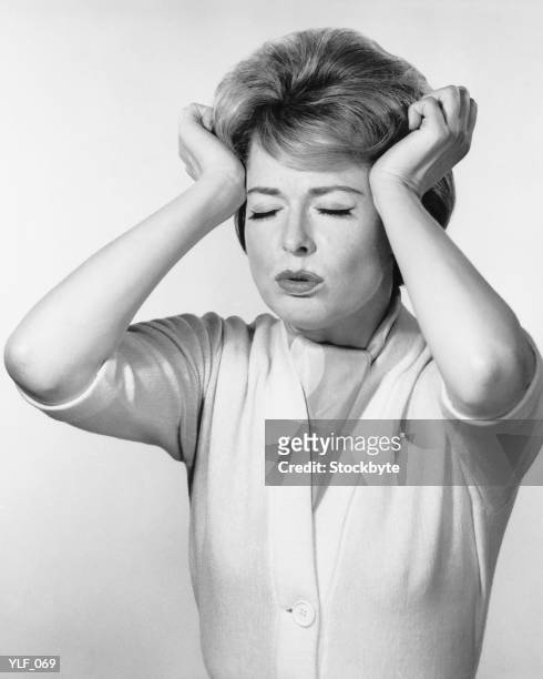 woman pressing hands against head - only mid adult women stock pictures, royalty-free photos & images