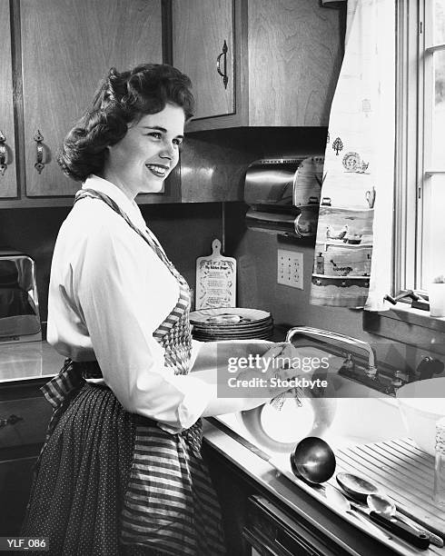 woman washing dishes in kitchen - in stock pictures, royalty-free photos & images