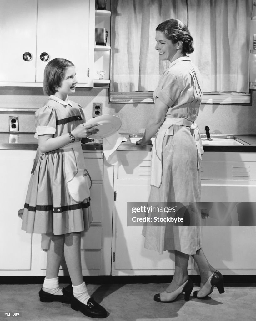 Mother and daughter doing dishes