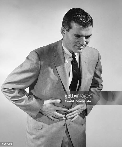 man holding stomach - only mid adult men stock pictures, royalty-free photos & images
