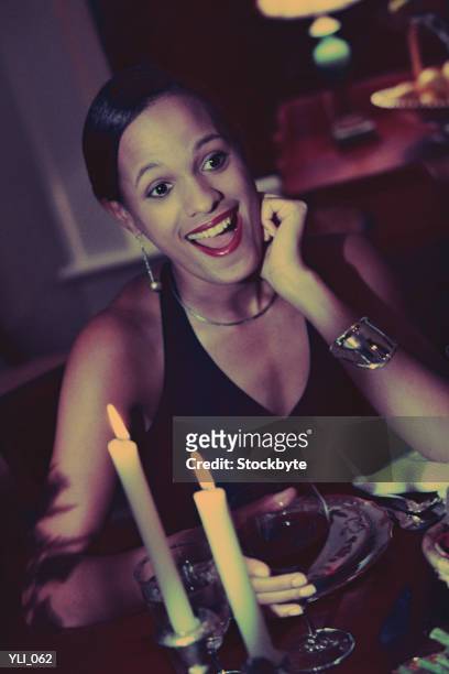 woman sitting at candlelit dinner table - wonder moments songs in the key of life performance tour philadelphia pennsylvania stockfoto's en -beelden