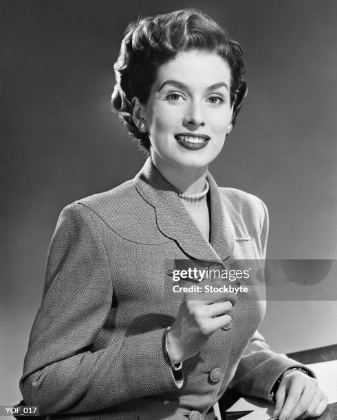 woman smiling, holding pen - writing instrument stock pictures, royalty-free photos & images