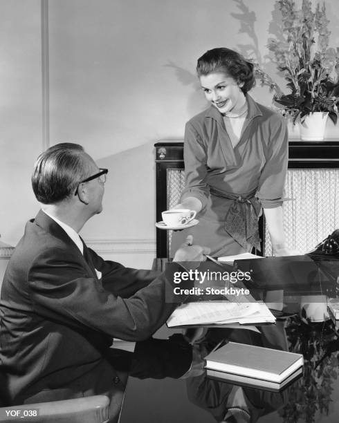 woman giving cup to man - secretary stock pictures, royalty-free photos & images