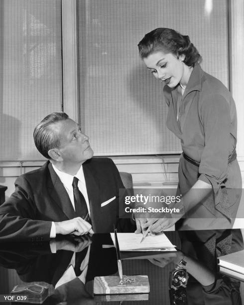 woman and man talking and pointing to paper - next to stock pictures, royalty-free photos & images