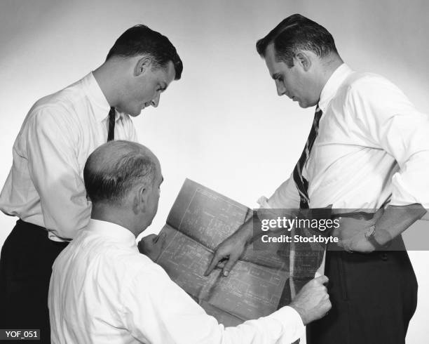 three men looking at blueprint - design occupation stock pictures, royalty-free photos & images