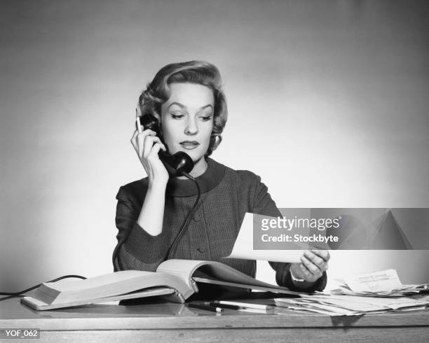 woman using phone and looking at paper - his and hers stock pictures, royalty-free photos & images