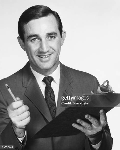 man holding clipboard and pencil - only mid adult men stock pictures, royalty-free photos & images