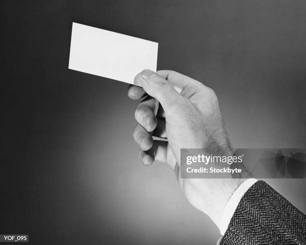 hand holding card - media gather outside of the home of business secretary vince cable after his comments on bskyb emerged stockfoto's en -beelden