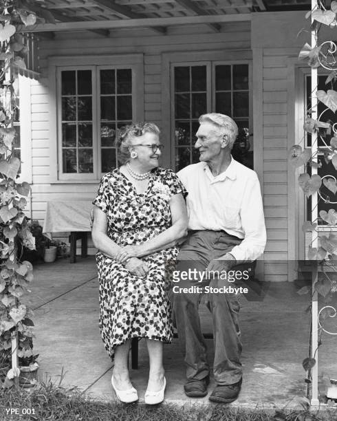 man and woman sitting on porch - his and hers stock pictures, royalty-free photos & images