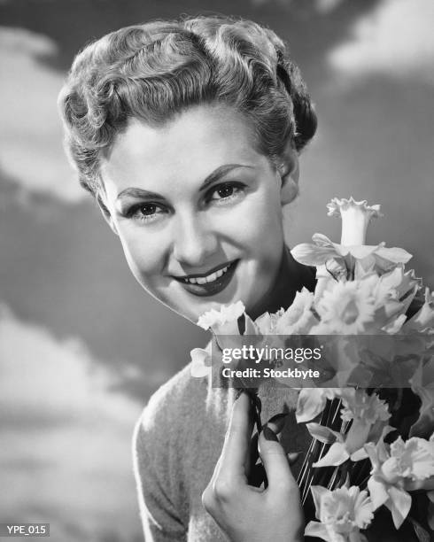 woman holding bunch of daffodils - a of stockfoto's en -beelden