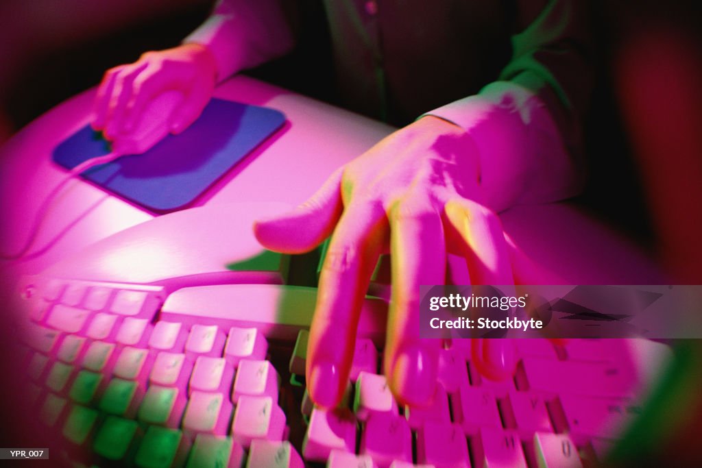 Woman using computer keyboard and mouse, close-up