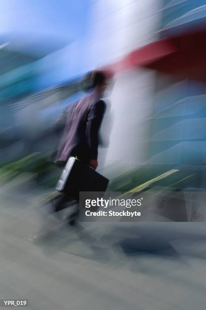 blurred figure walking - media gather outside of the home of business secretary vince cable after his comments on bskyb emerged stockfoto's en -beelden