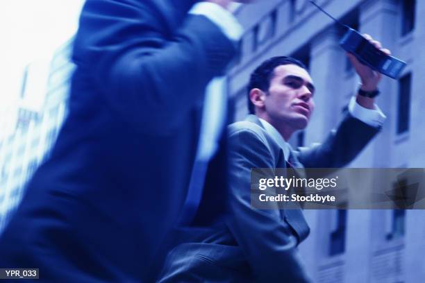 two men running down street, hailing a cab - a of of imagens e fotografias de stock