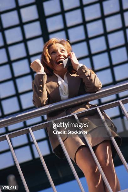 woman talking on cellular phone - media gather outside of the home of business secretary vince cable after his comments on bskyb emerged stockfoto's en -beelden