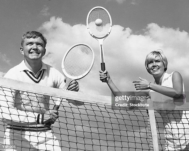 man and woman playing tennis - doubles sports stock pictures, royalty-free photos & images