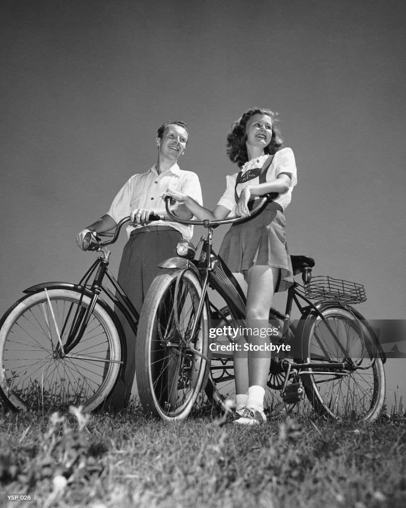 Couple standing with bicycles
